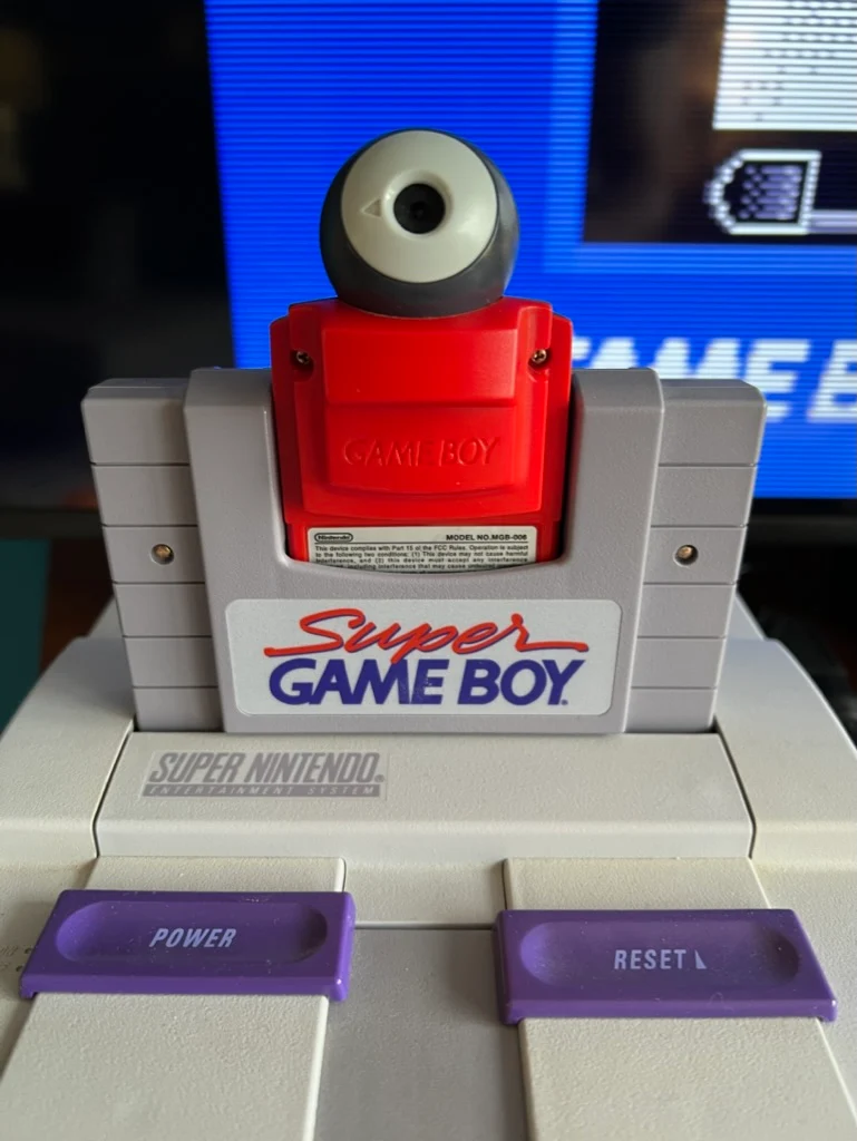 A Game Boy Camera device inside a Super Game Boy cartridge on an SNES console.