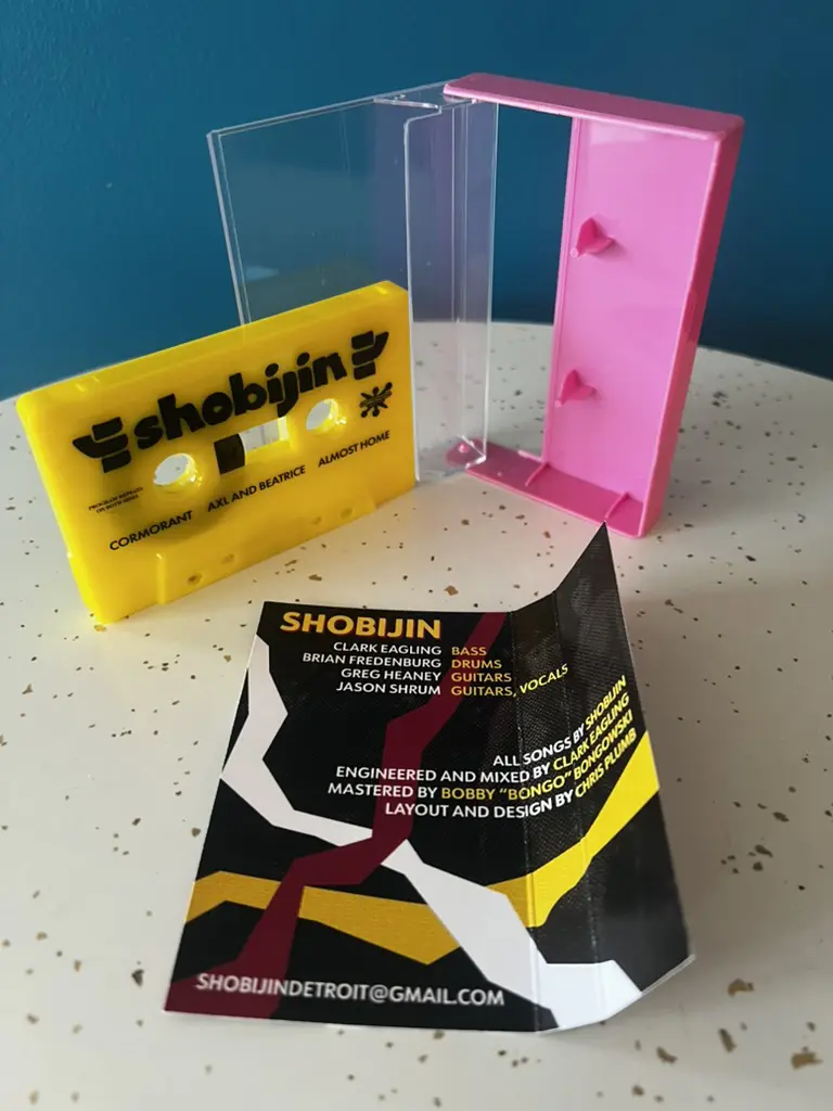 The Shobijin cassete tape, opened and expanded to reveal the interior liner notes.