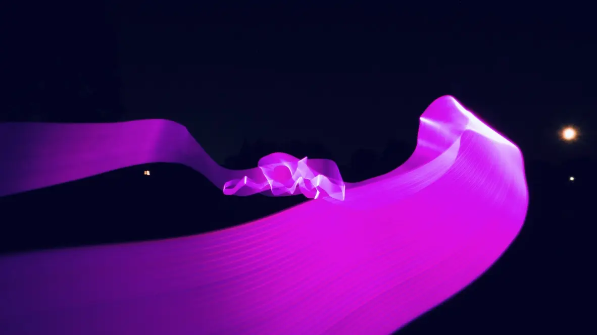 Experimental photograph with psychedelic, colorful shapes in a field outdoors at night.