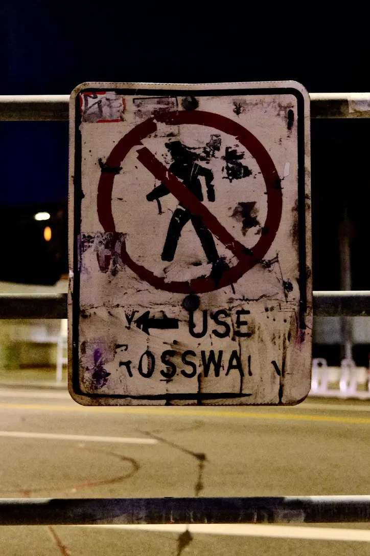 A distressed crosswalk sign in Los Angeles.